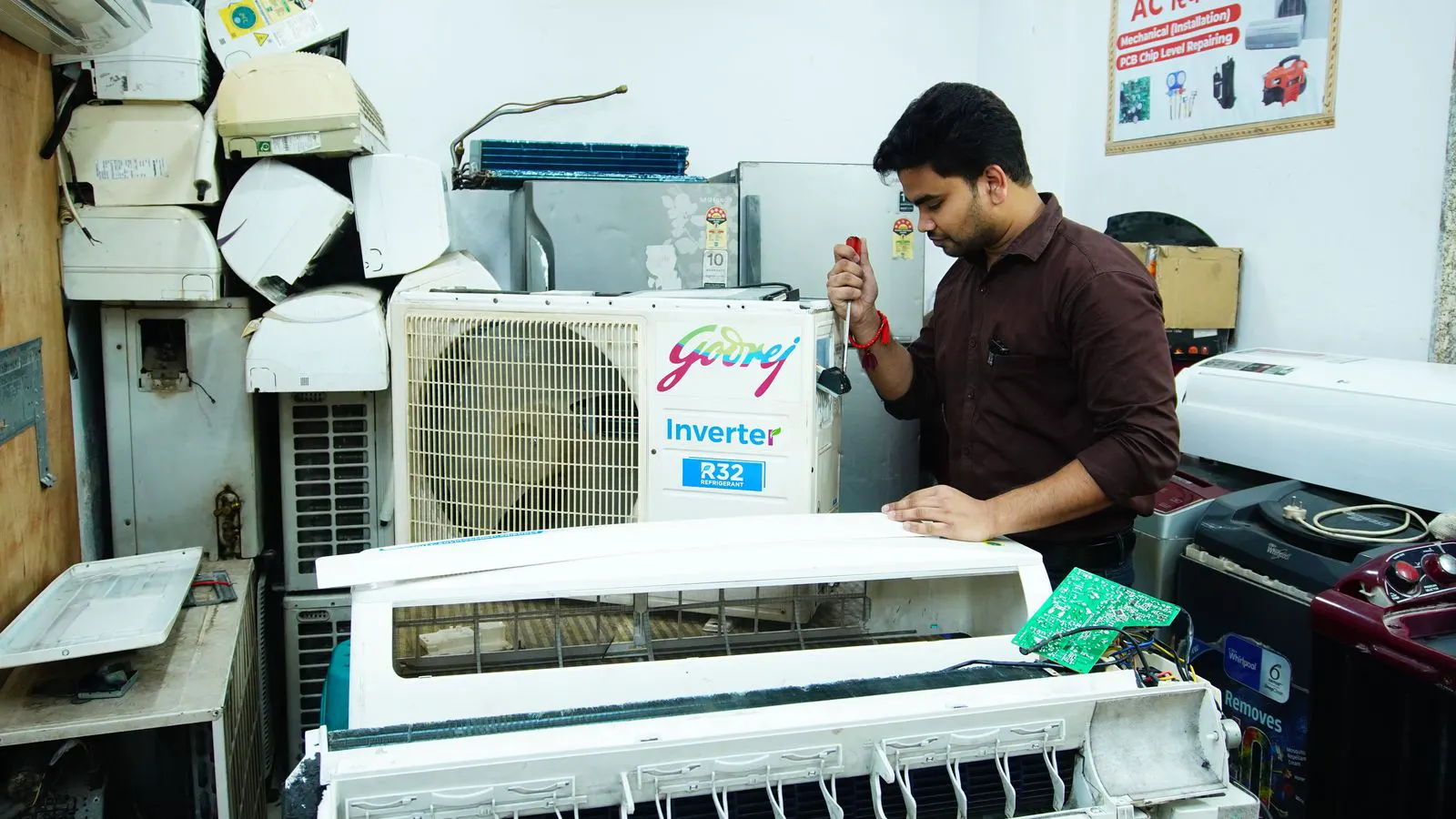 Technician inspecting a clogged air compressor line with a filter