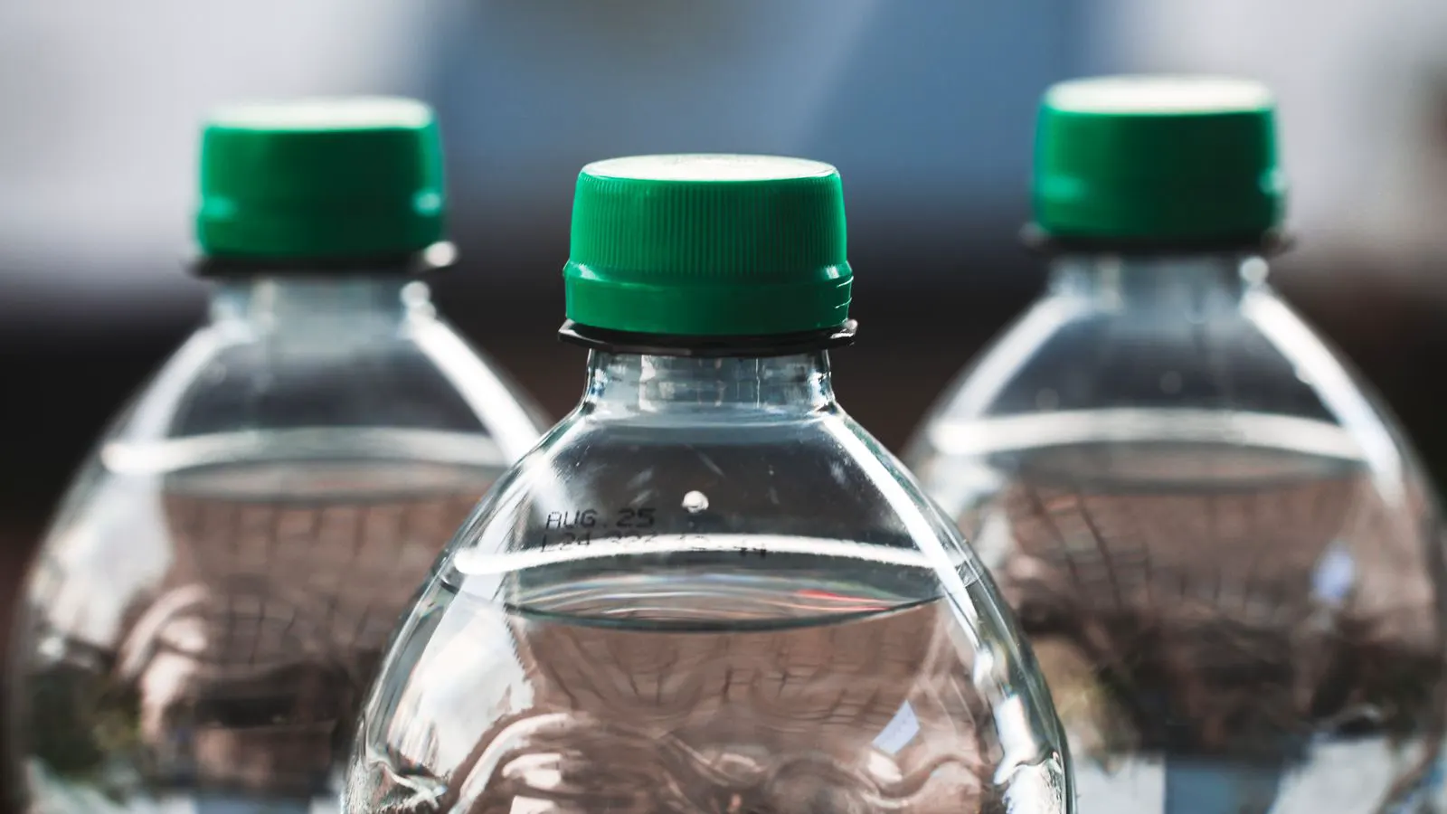 A blow molding machine forming a clear plastic bottle in production