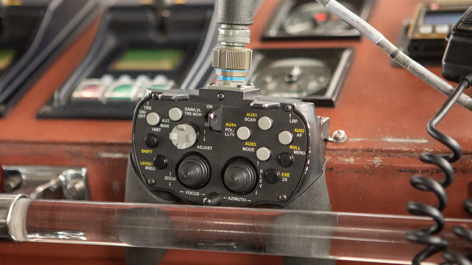Close view of an injection molding machine control interface and motor housing.