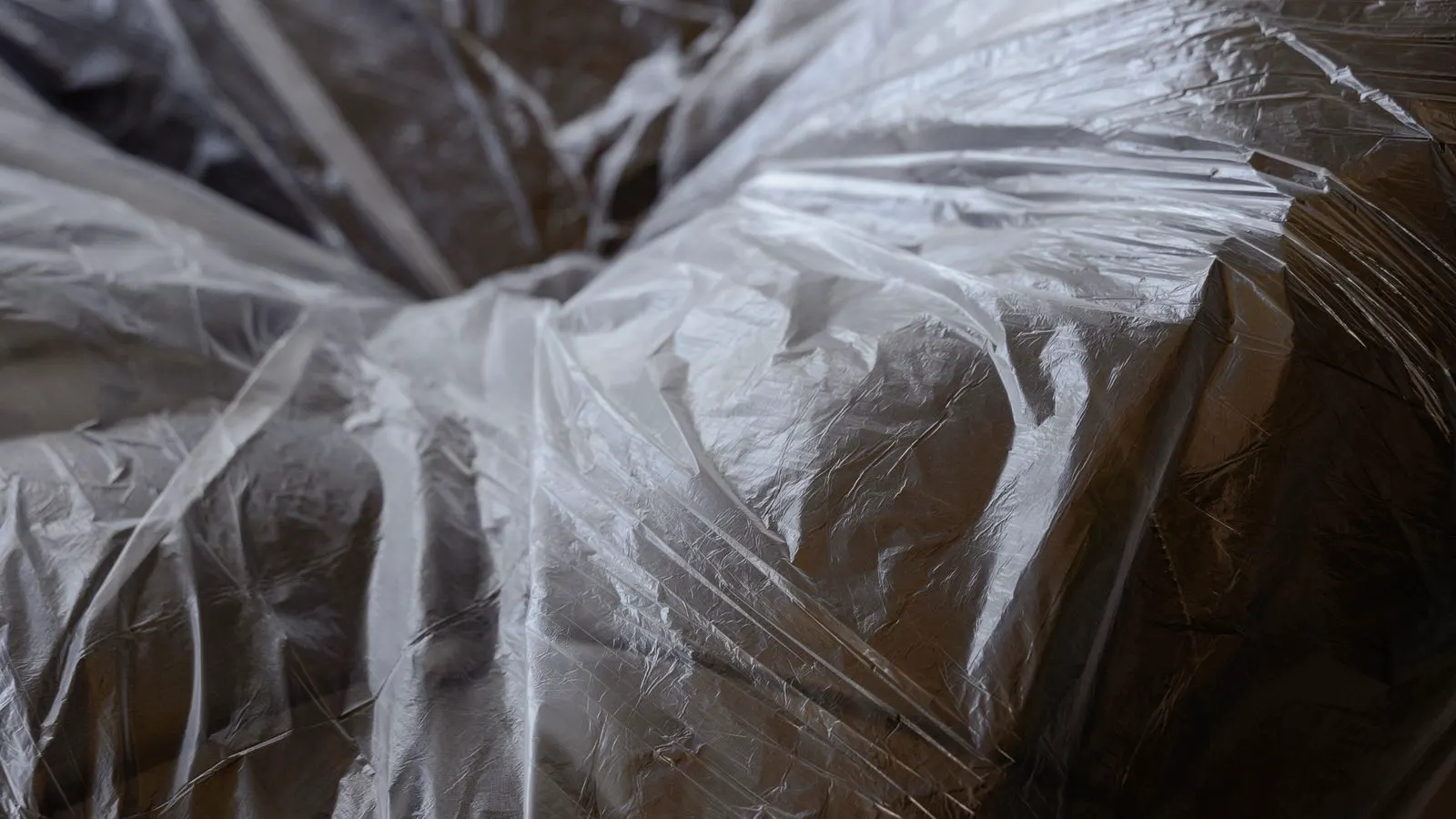 A close up view of a cooling jacket wrapped around an extruder barrel