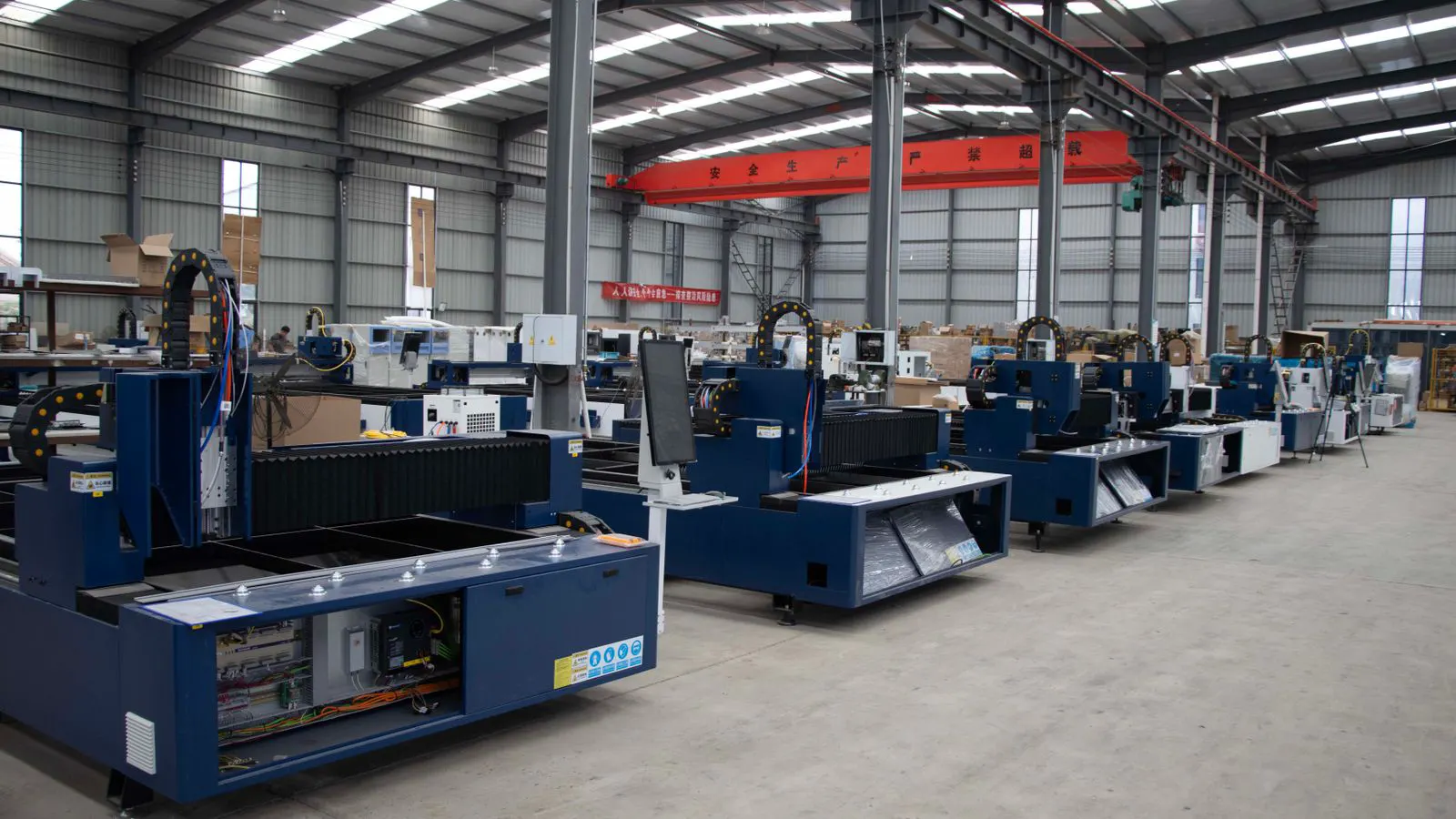 A modern blow molding machine running on a factory floor