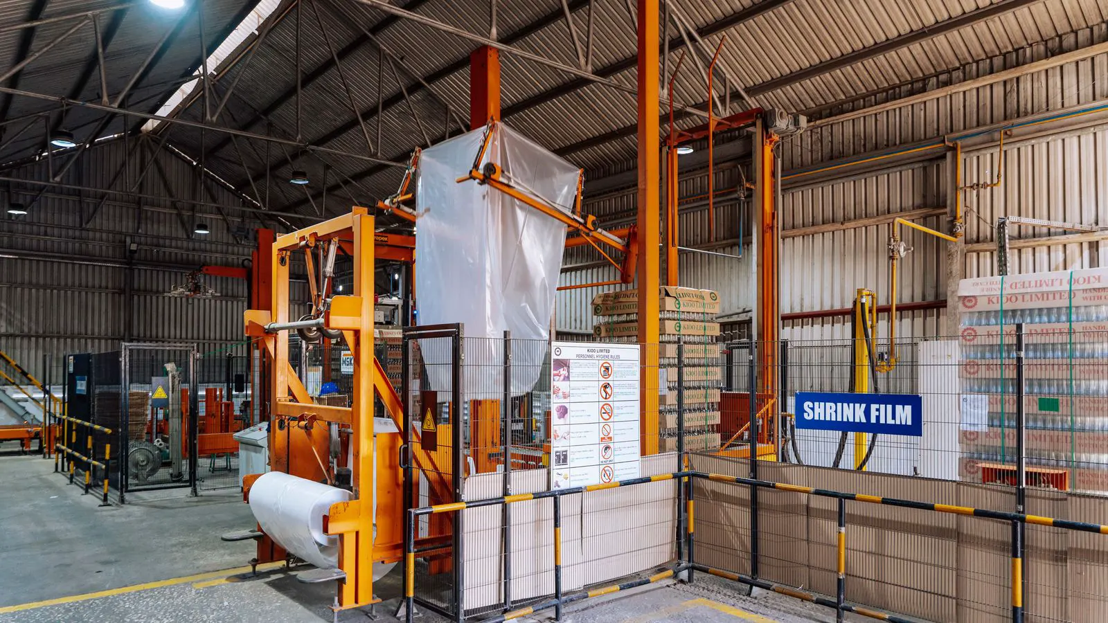 A large industrial plastic mixer with an auger shaft and discharge chute.