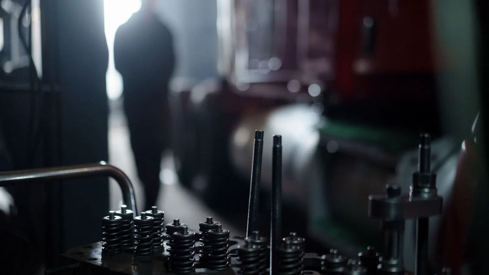 Technician inspecting plastic machine spare parts in a warehouse