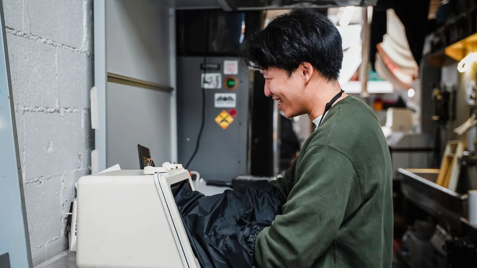 An injection moulder machine sits in a modern factory floor