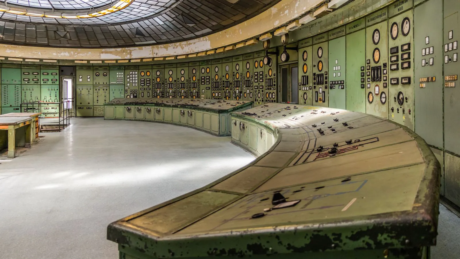 A modern extrusion plant control room with digital displays and monitoring screens.