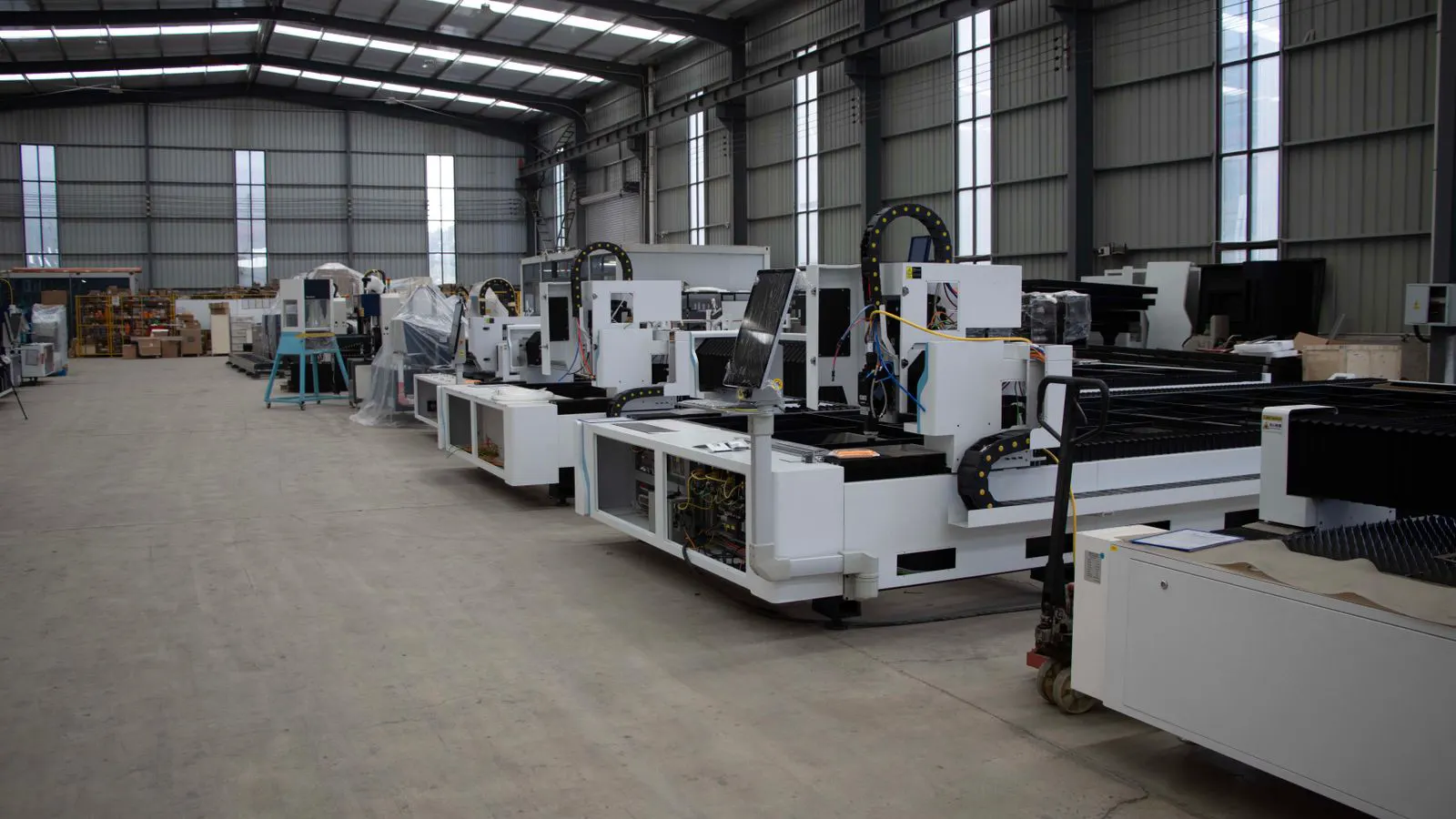 A modern blow molding machine in a factory with visible sensors