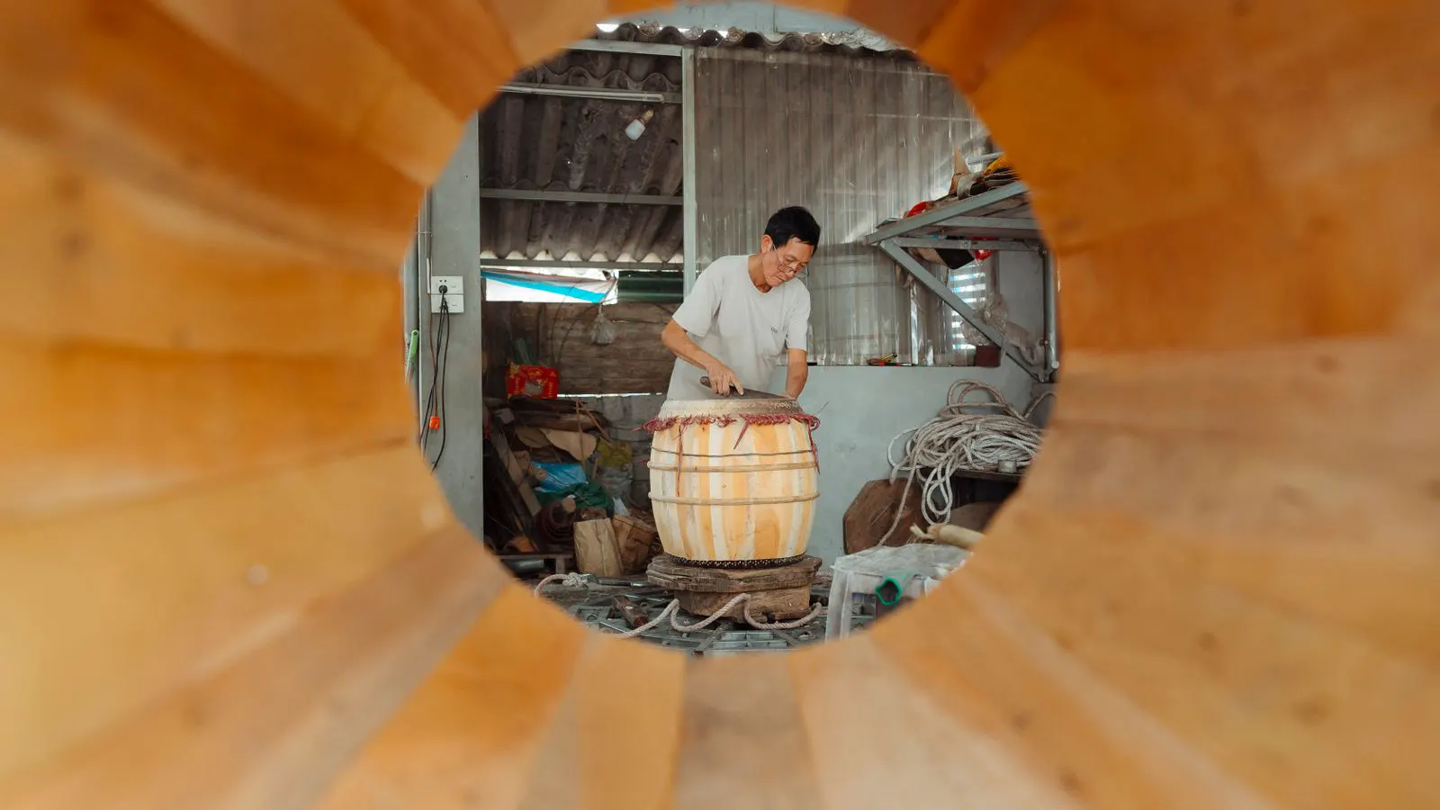A long metal extruder barrel with heating bands installed on a machine.