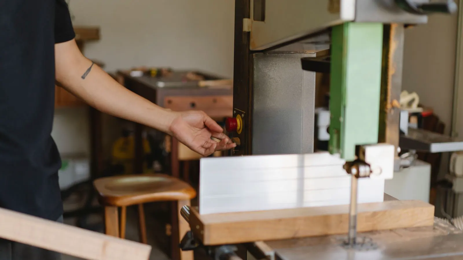 operator adjusting settings on an industrial edge banding machine