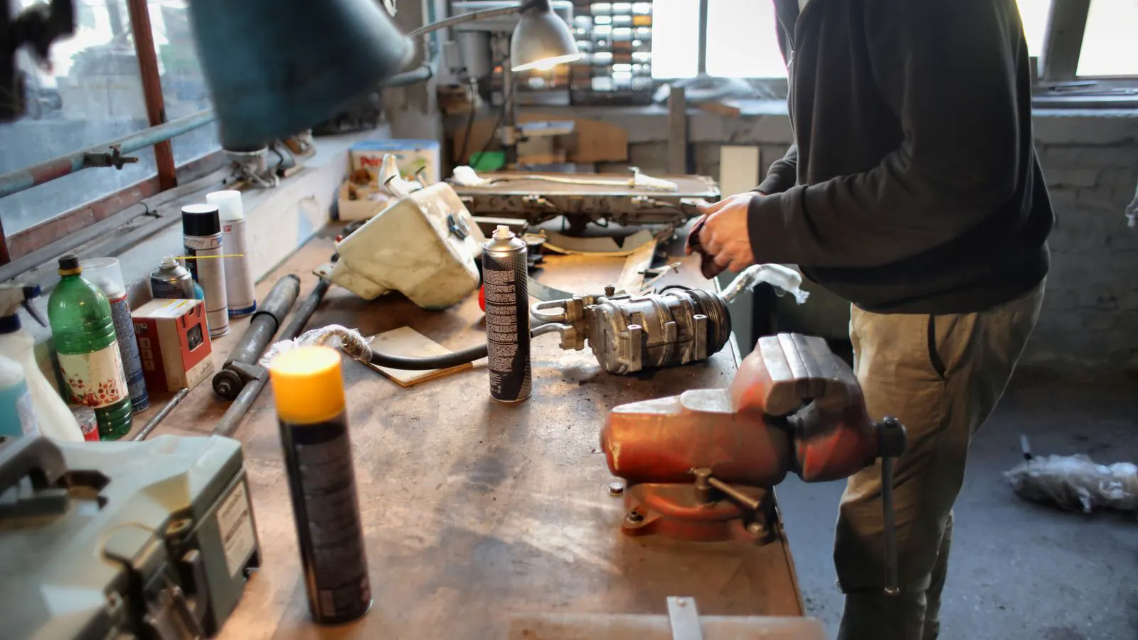 A technician inspecting a woodworking machine in a workshop