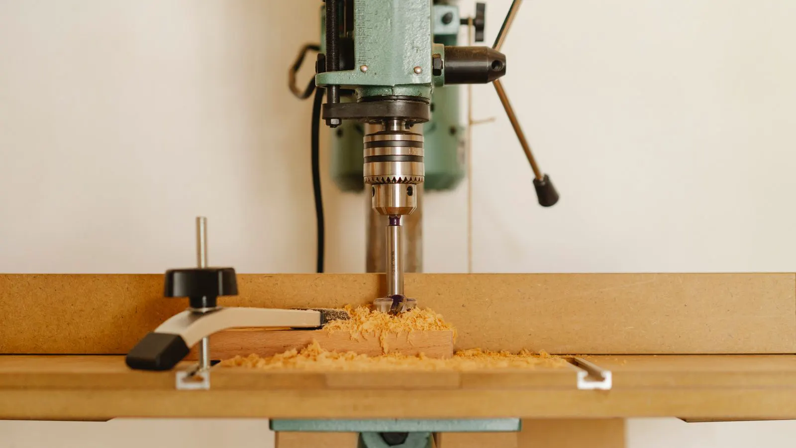 A continuous edge banding machine processing wooden panels in a factory