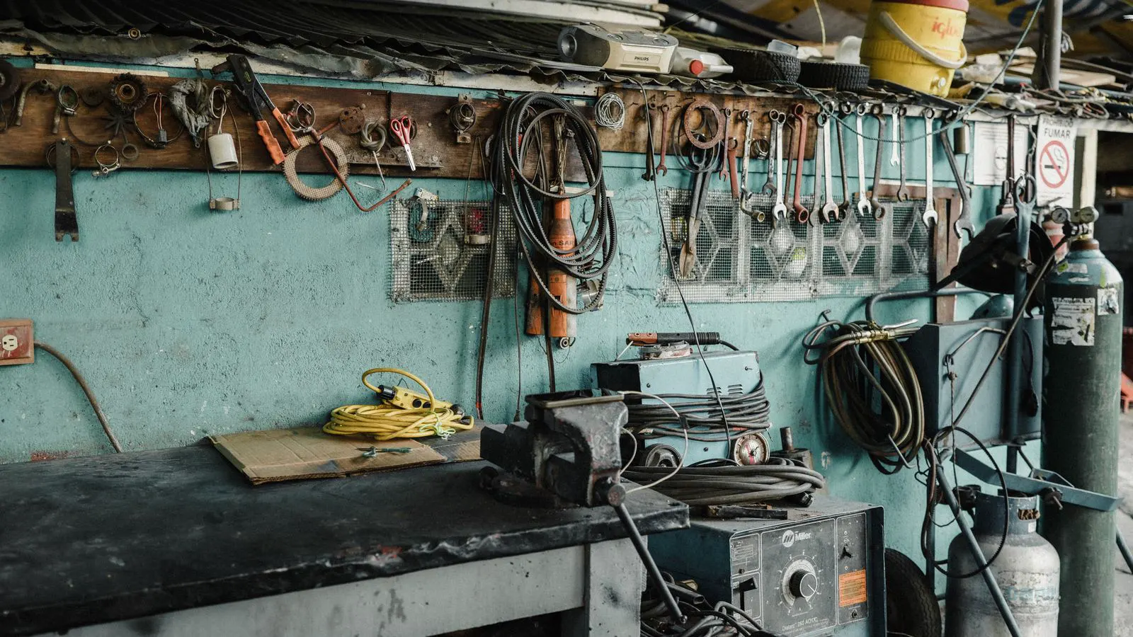 A technician inspecting a machine spindle with a wrench