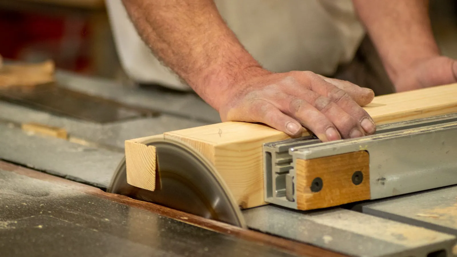 A technician checking a panel saw blade with a digital device