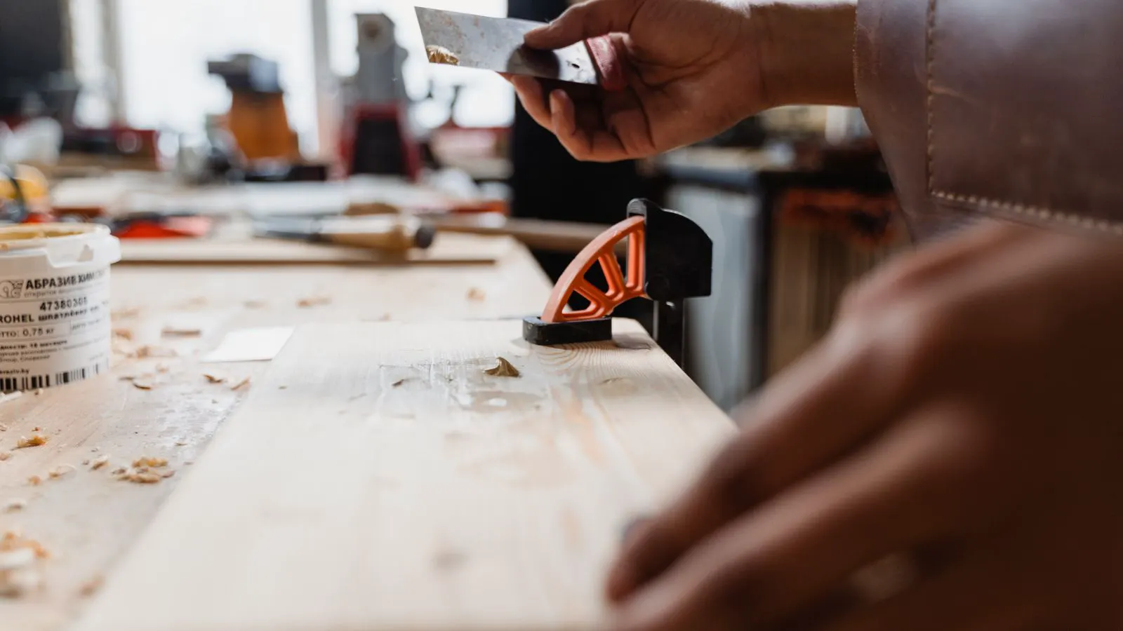 A hot melt adhesive applicator applying a bead to a panel edge