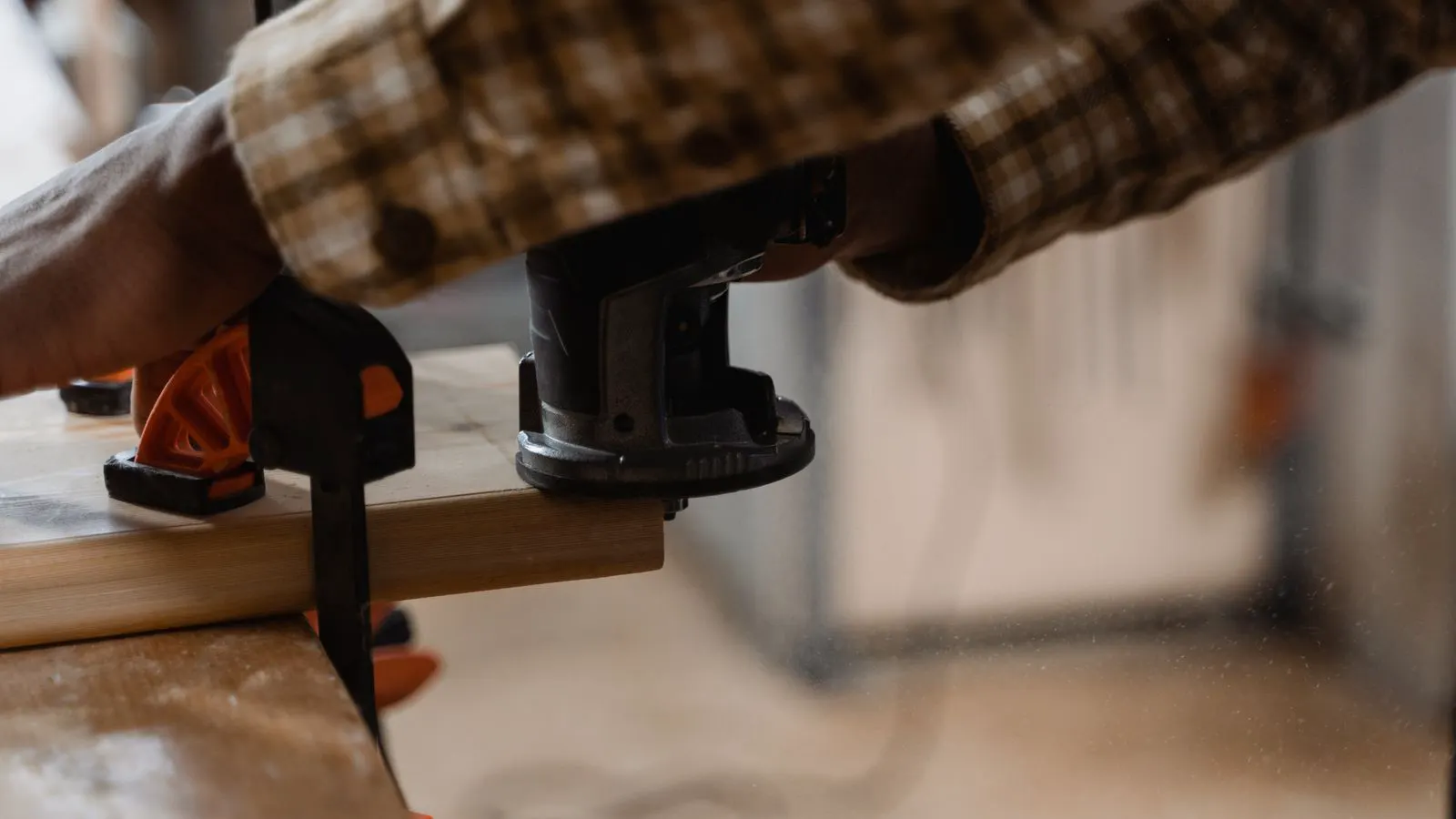 A cnc router spindle cutting a board in a workshop.