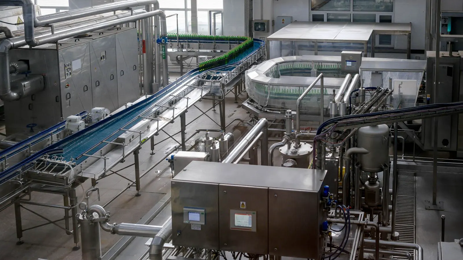 A modern edge banding machine runs panels through a finished line