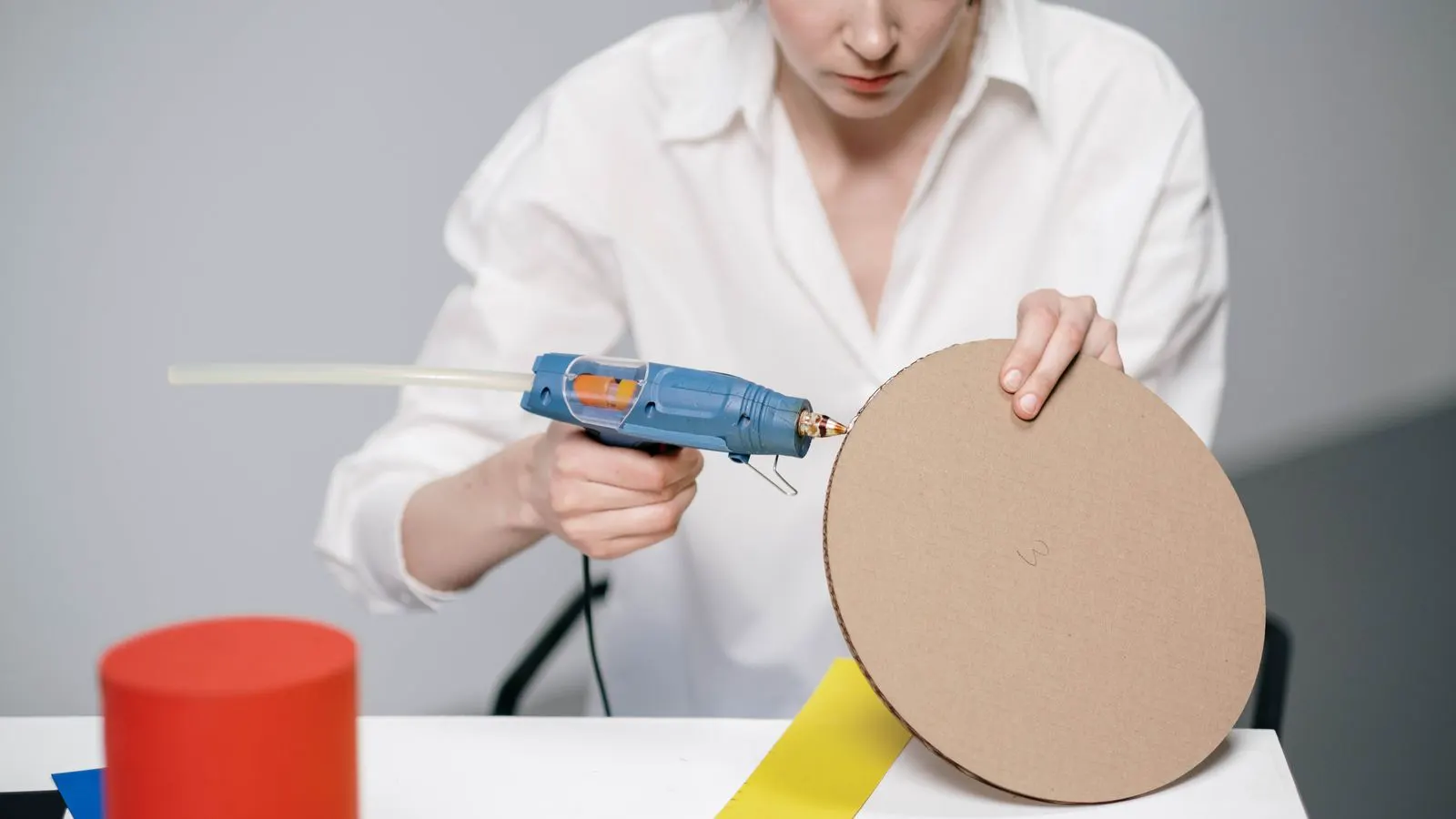 Edge banding machine rollers applying adhesive to a wood workpiece