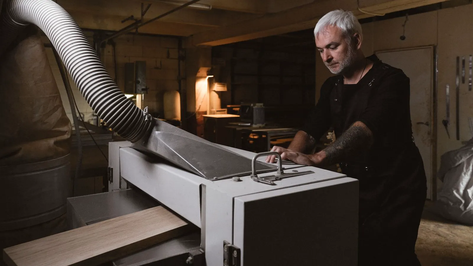Technician checking a woodworking machine in a workshop