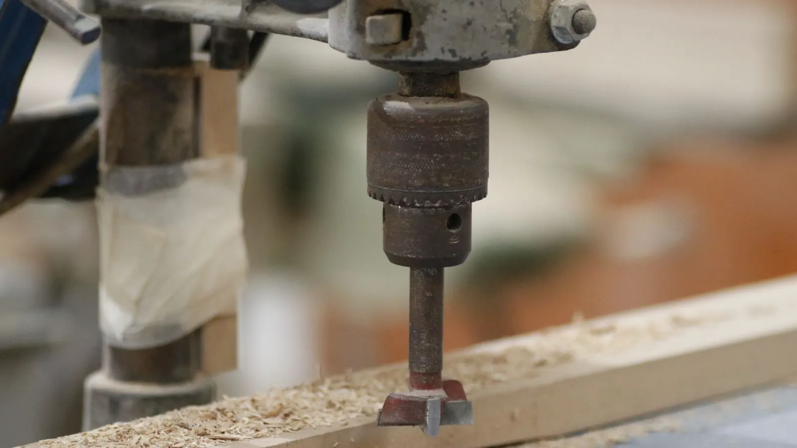 Technician checking a new woodworking machine in a factory workshop