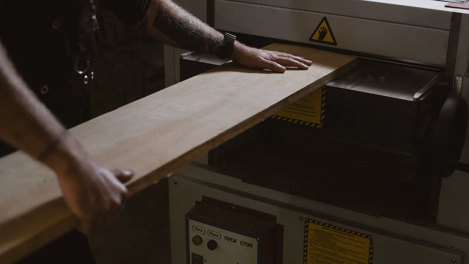 A large flat CNC router table in a professional woodworking shop.