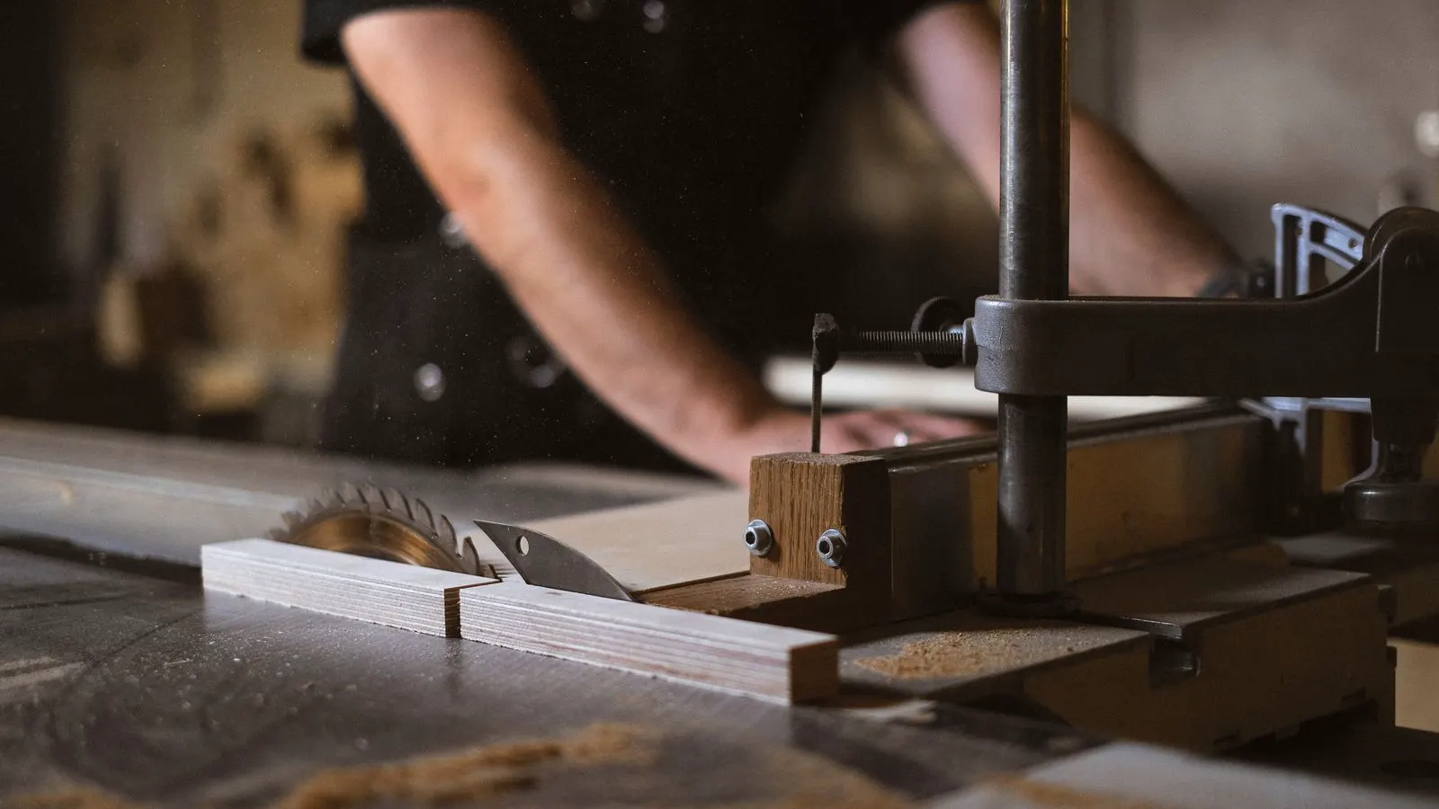 A wooden workpiece being shaped by a CNC router bit in a workshop.