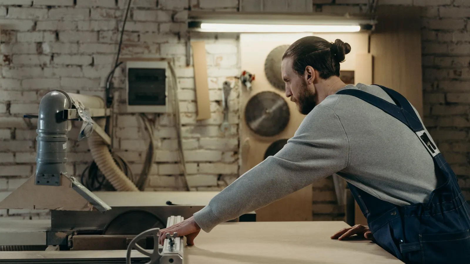 Technician inspecting a circular saw blade guard assembly