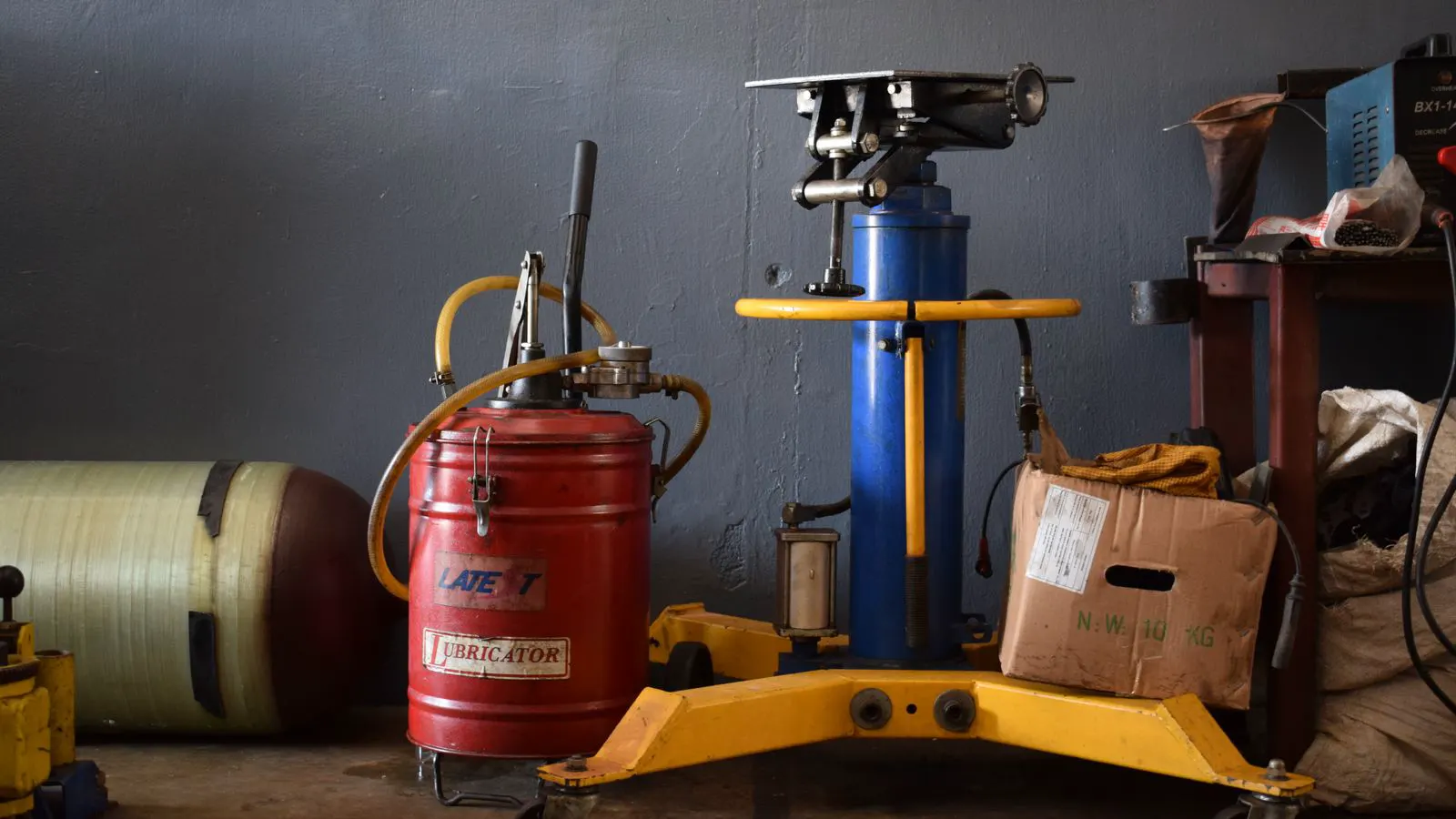 A professional workshop scene showing a dust collector unit near workstations.