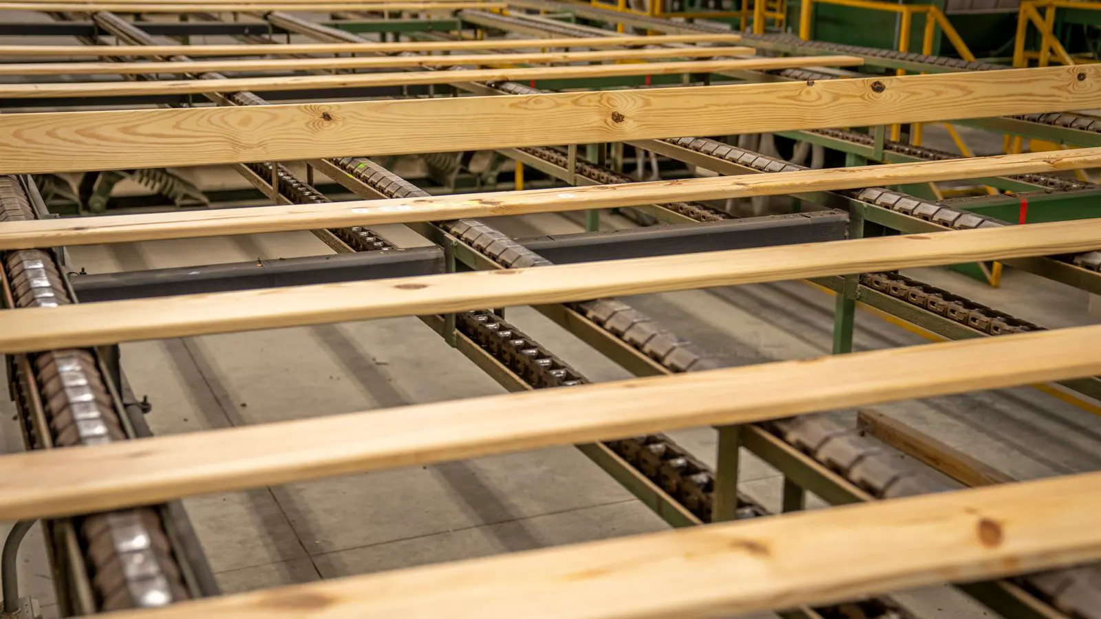 A technician checks a CNC router and a panel saw in a workshop