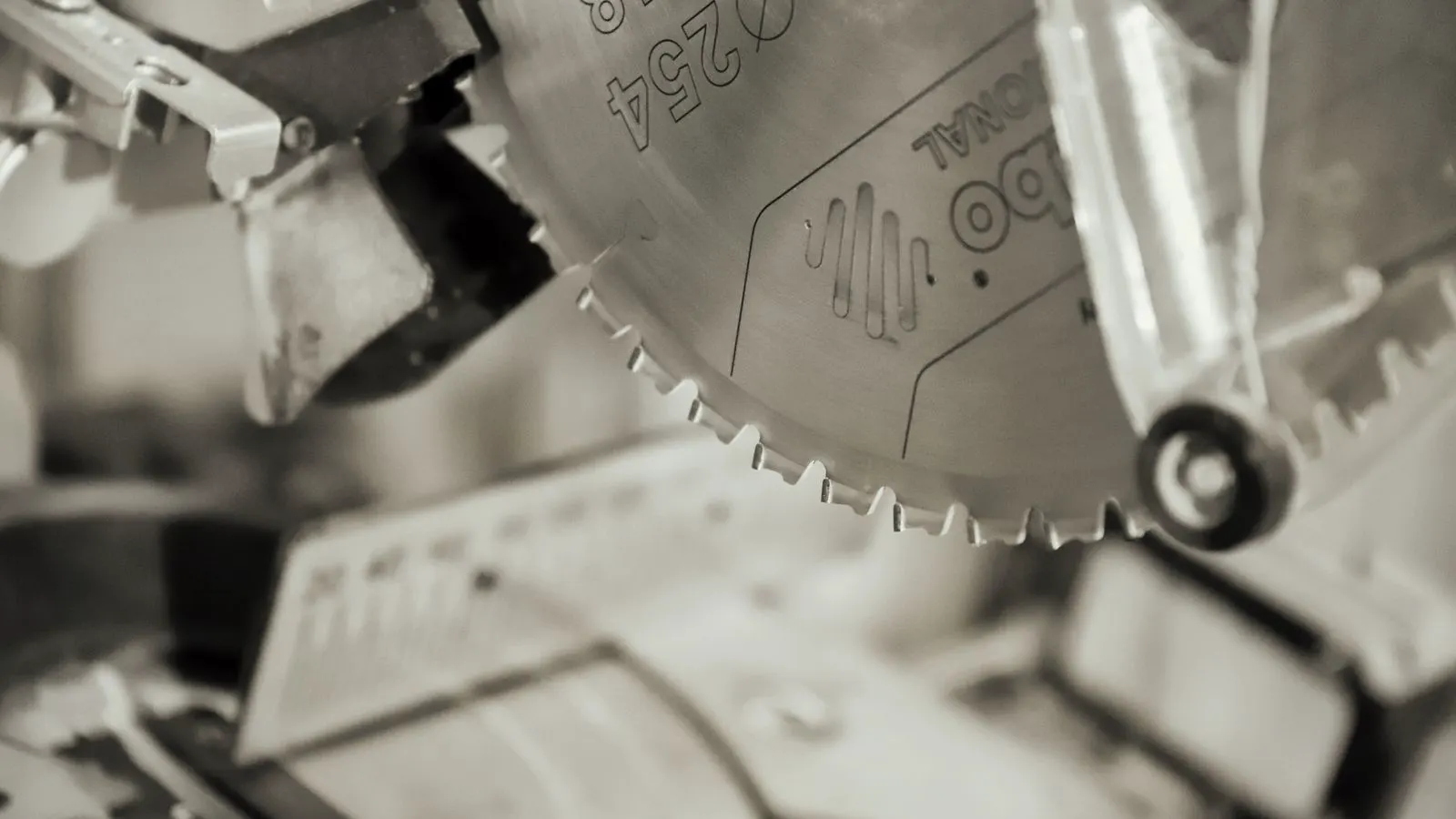 Close up of a circular saw blade mounted on an industrial table saw arbor.