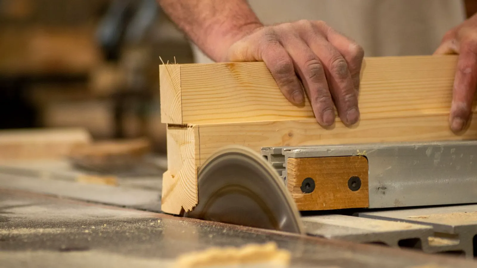 A panel saw and CNC router sit side by side in a clean woodworking shop