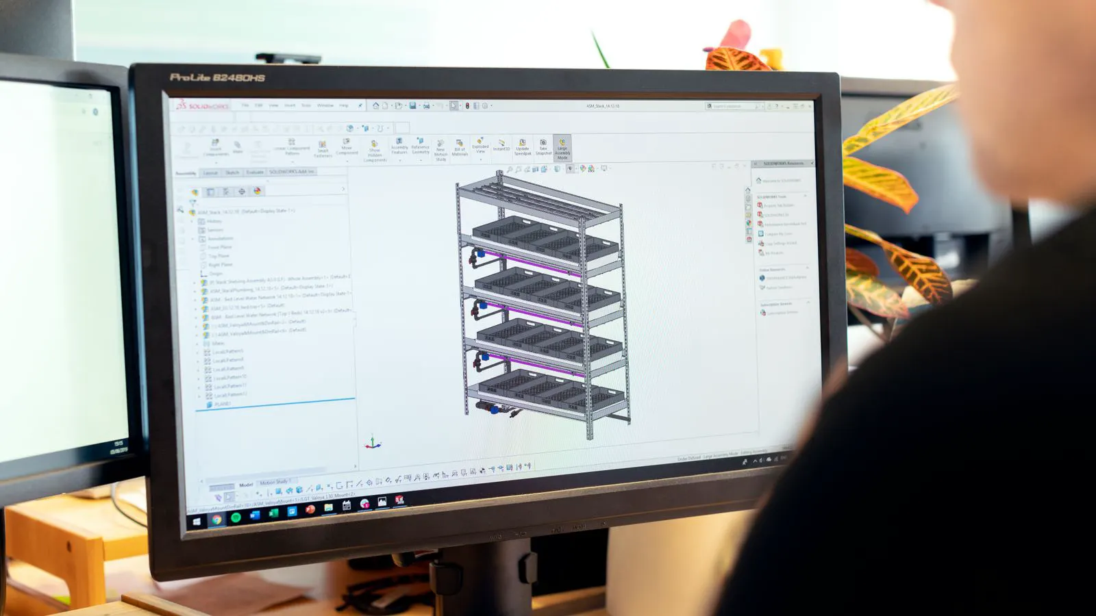 Engineer reviewing a CAD model of a machined part