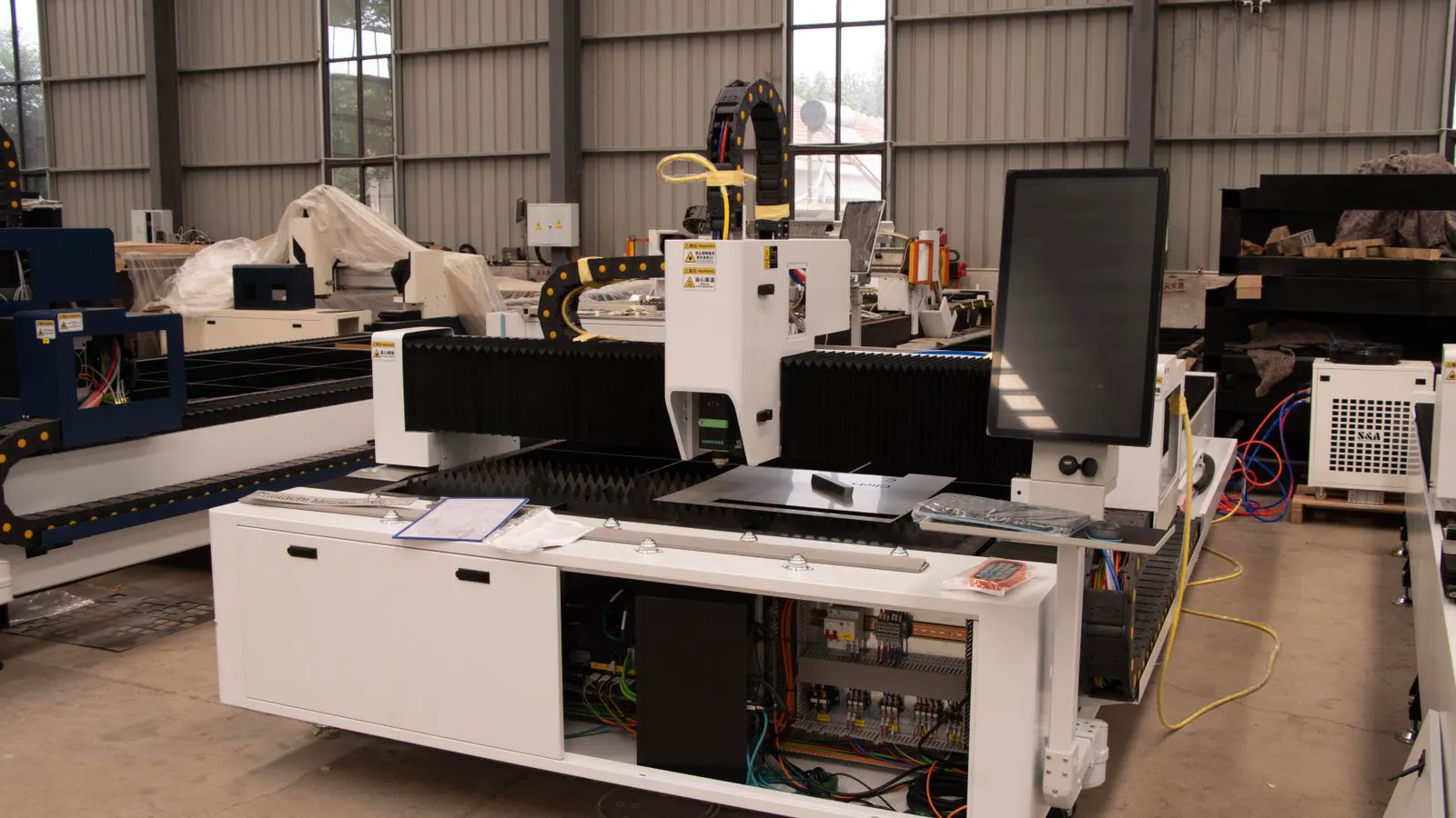 A CNC milling machine cuts a block of engineering plastic.