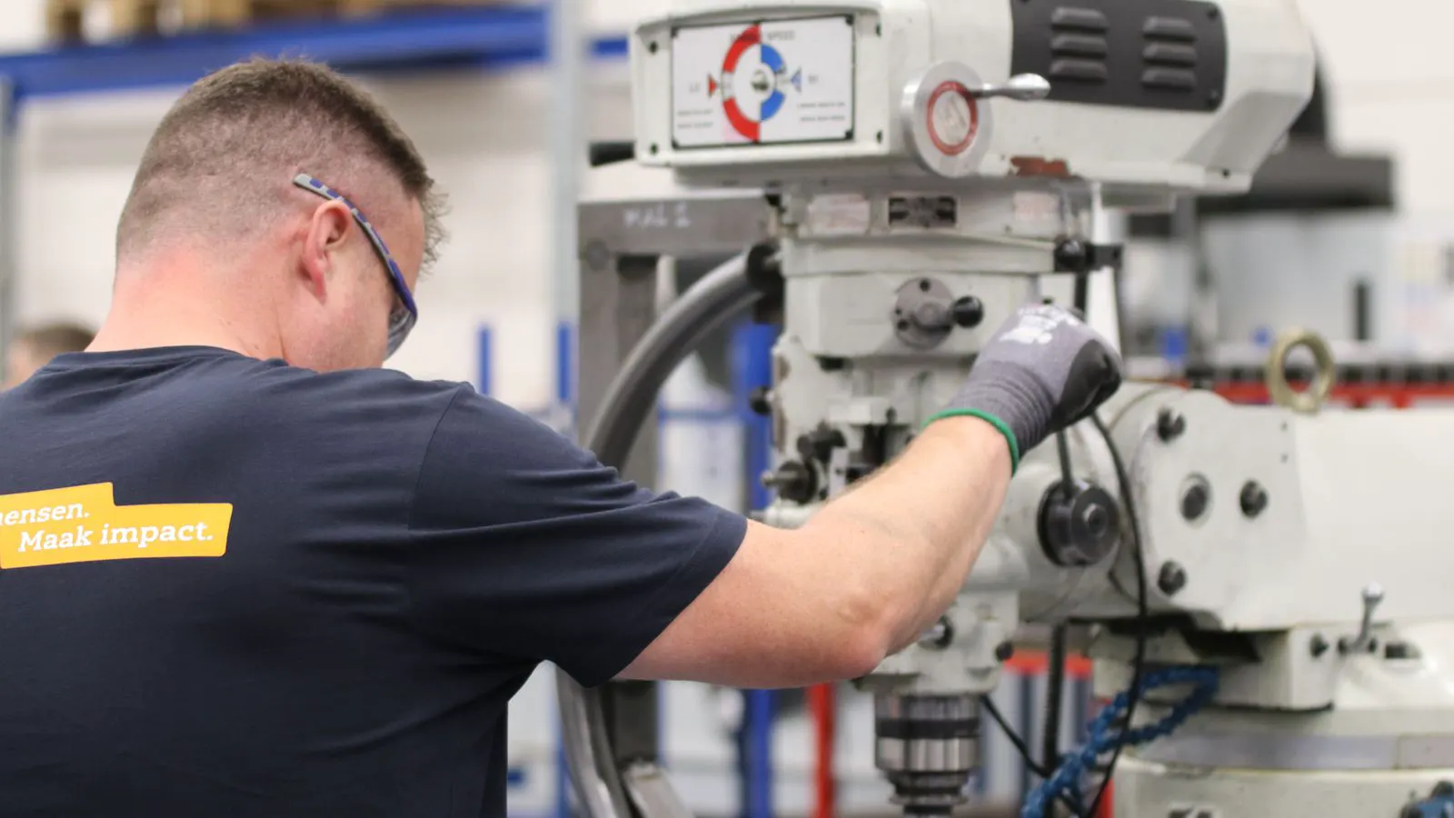 A close-up view of a CNC machine cutting a metal part with a tool.
