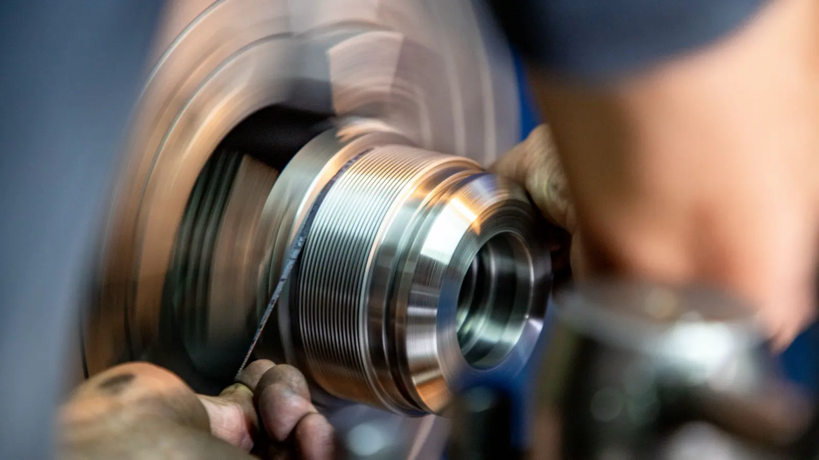 A CNC mill cutting a metal bar during production