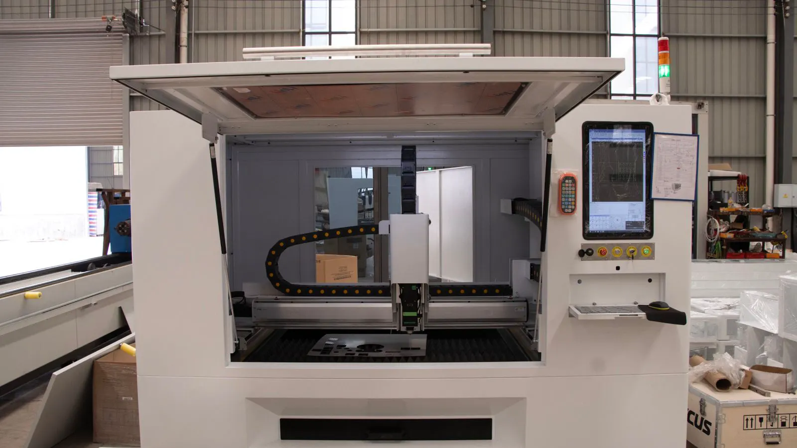 A CNC router cutting an aluminum bar with visible chip removal.