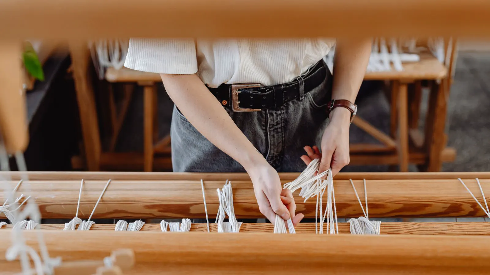 A technician inspecting a modern textile loom in a factory