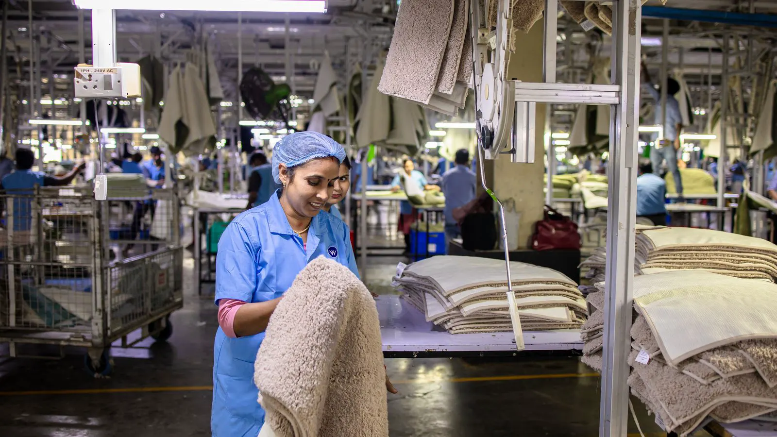 Operators monitoring production data on factory floor screens