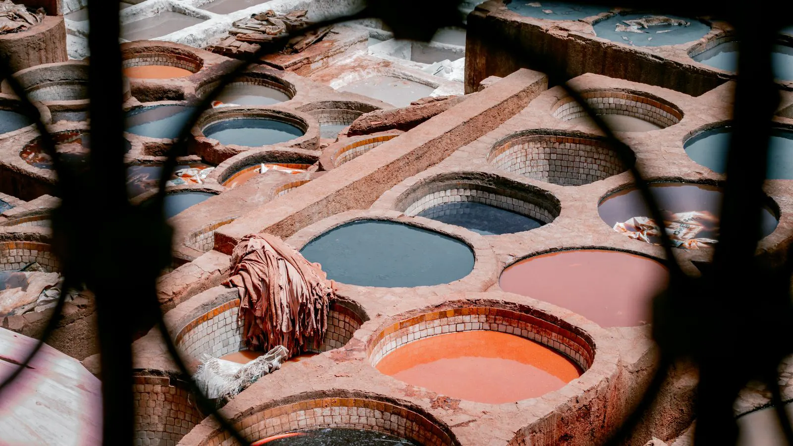 A large industrial dyeing vat with fabric suspended inside