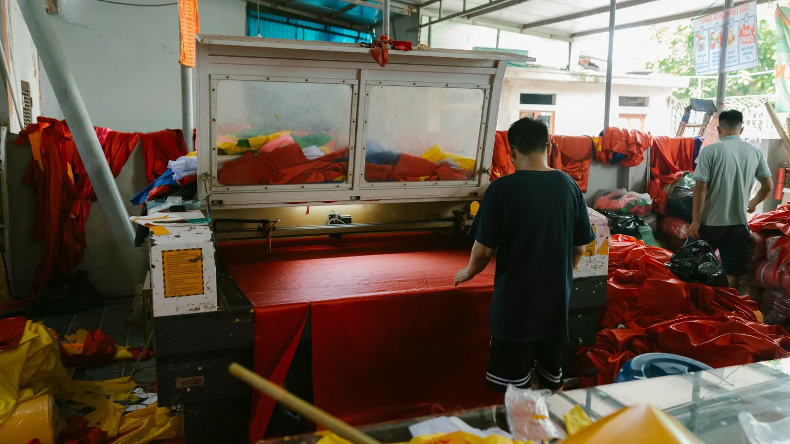 A technician inspecting a power loom in a factory