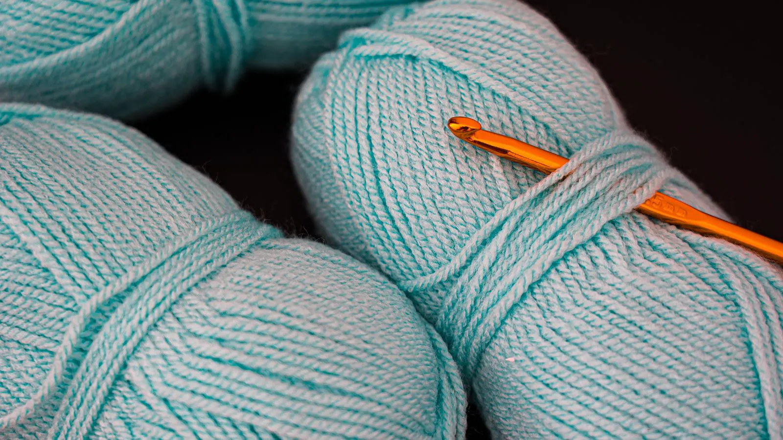 Close up view of yarn feeding into a knitting machine.