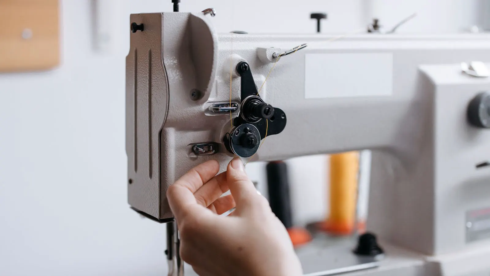 Close up of thread path on industrial sewing machine