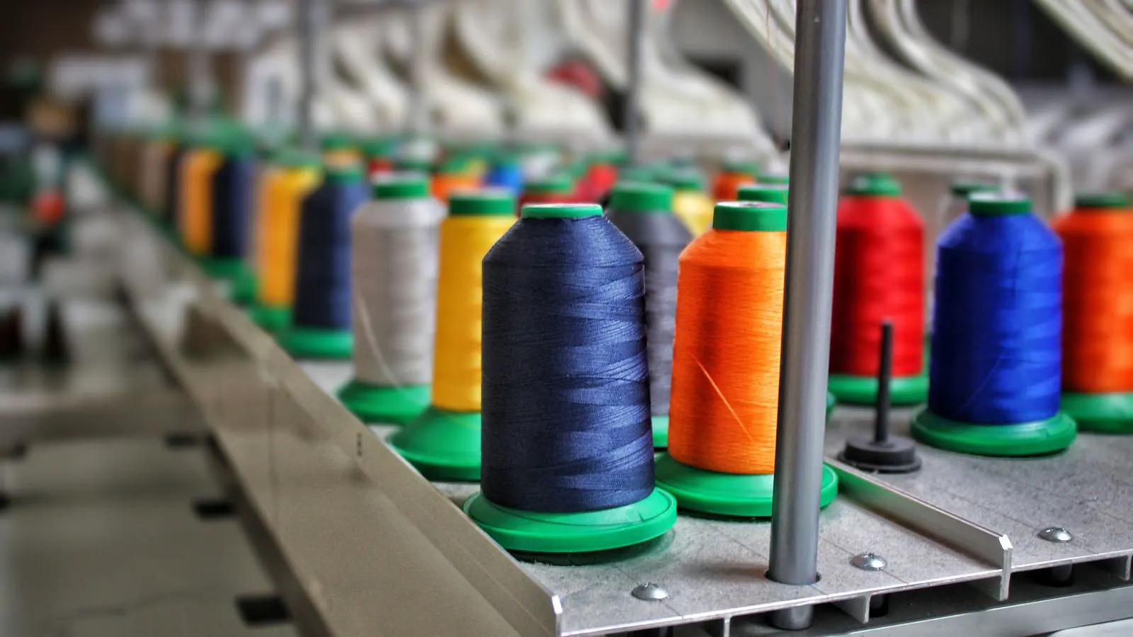 Close view of textile machinery with visible sensor components