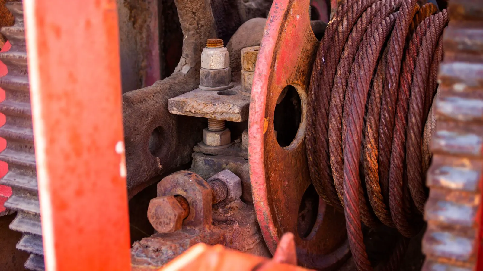 A close-up view of metallic gears and shafts inside a textile machine.