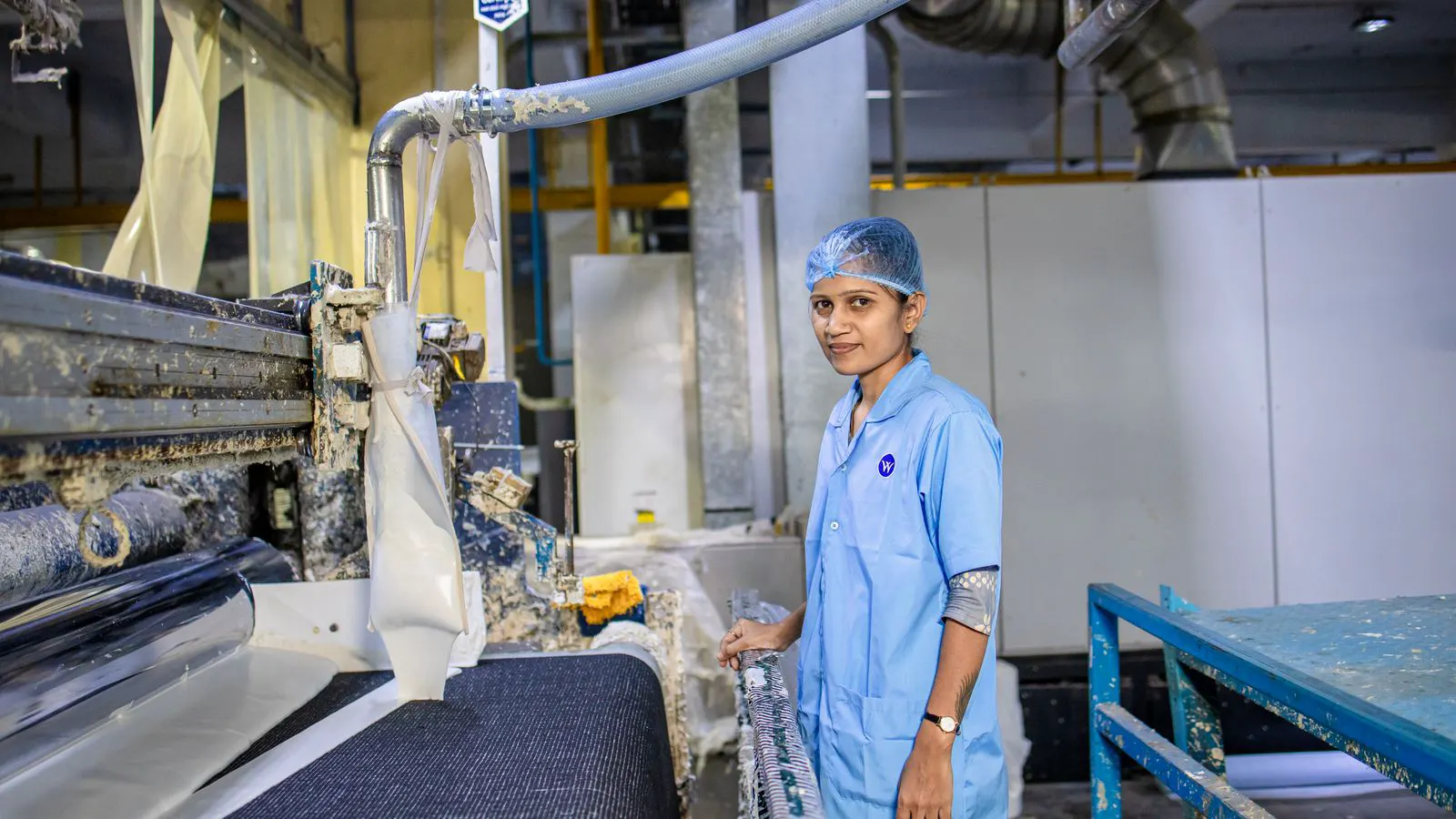 Close view of a stainless steel dyeing machine with a water inlet valve.
