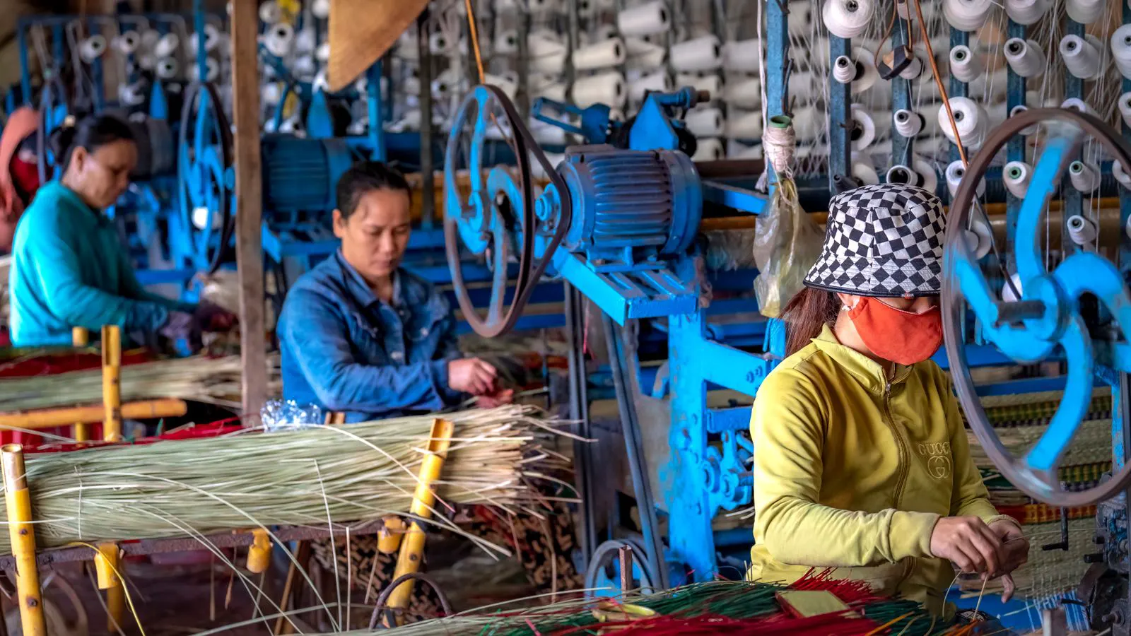Technician inspecting wiring on a modern power loom control panel