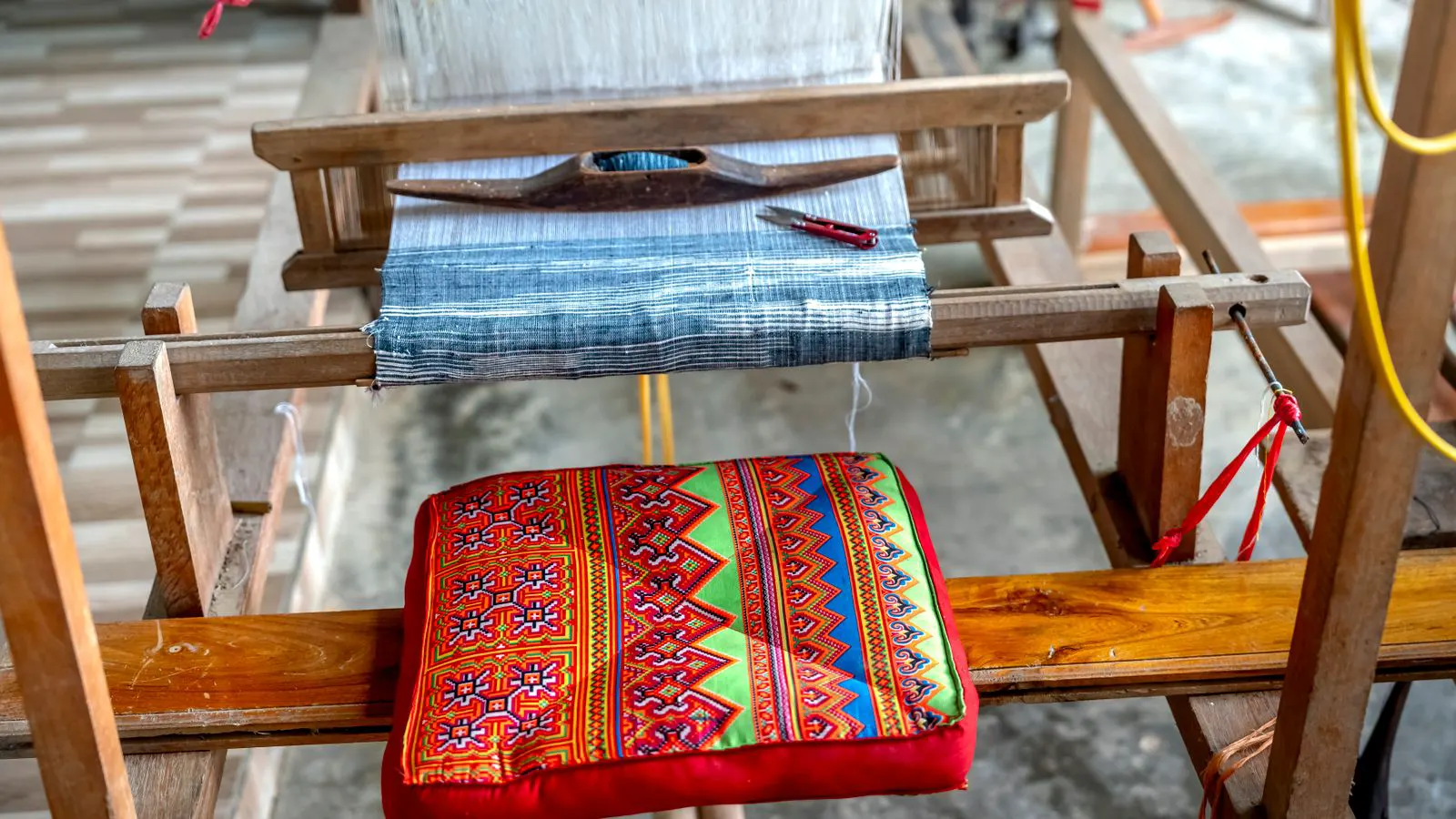Close up view of a loom shuttle inside the loom frame