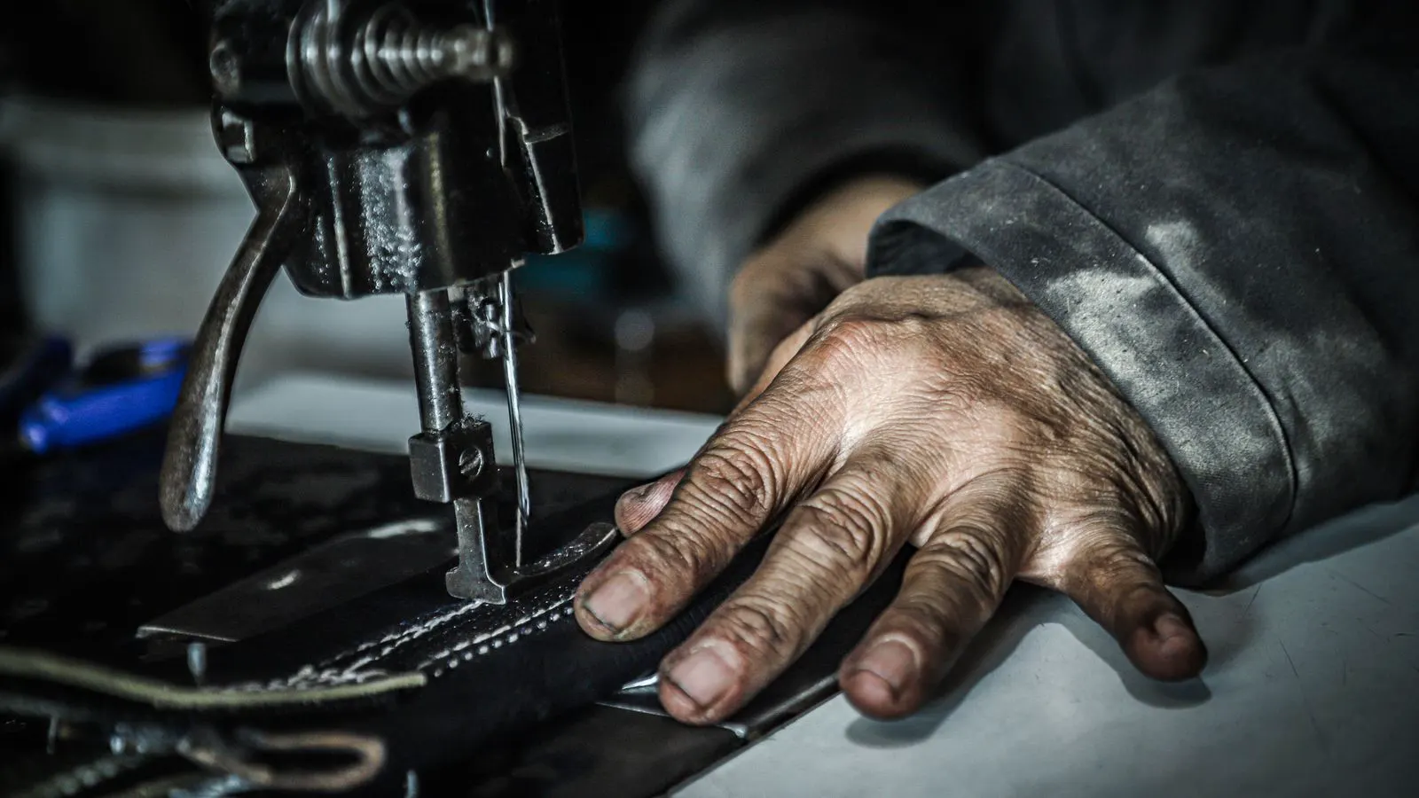 Close-up view of an industrial sewing machine thread path