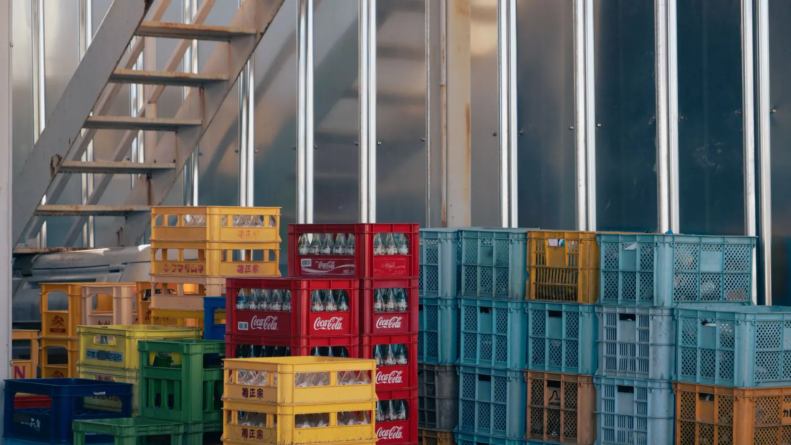 A worker checks a labeled resin bag in a warehouse.