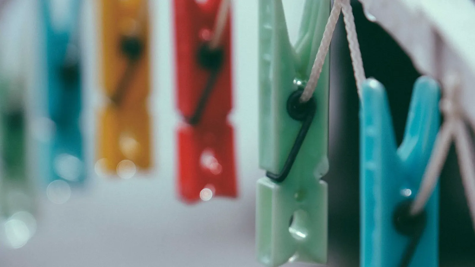 Polycarbonate resin pellets next to a printed technical datasheet
