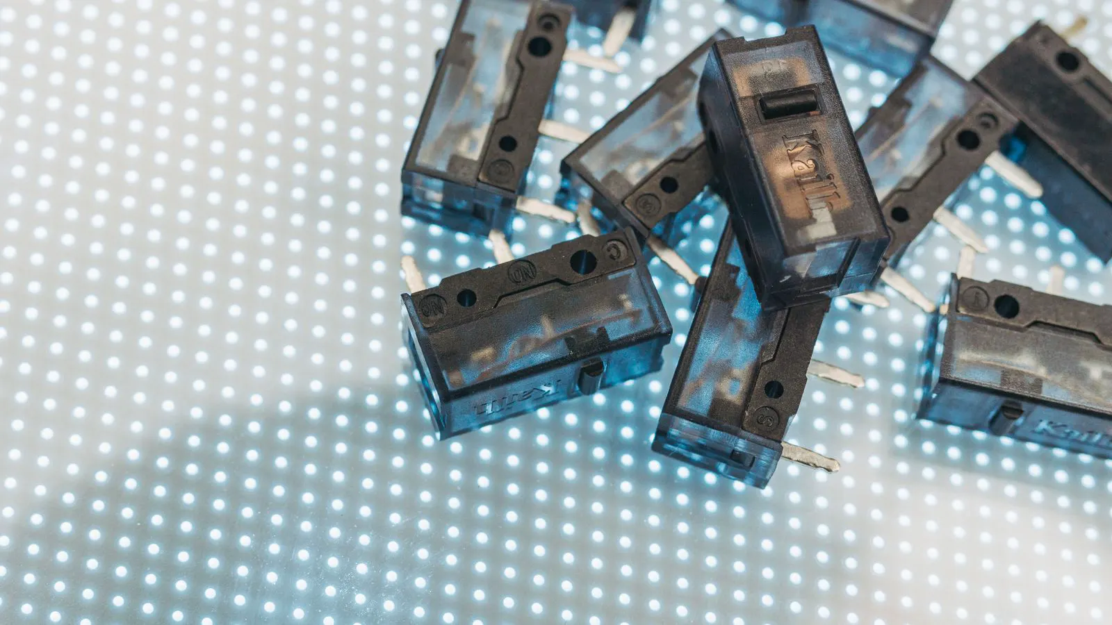 Close view of a thin plastic part showing a dimple on the surface.