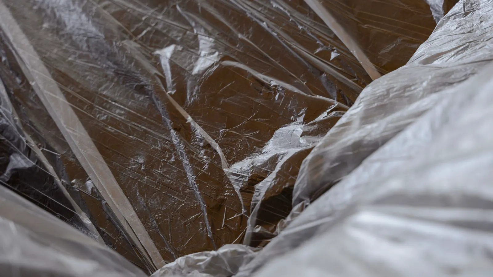 Close up of a white plastic part with a cracked surface line.